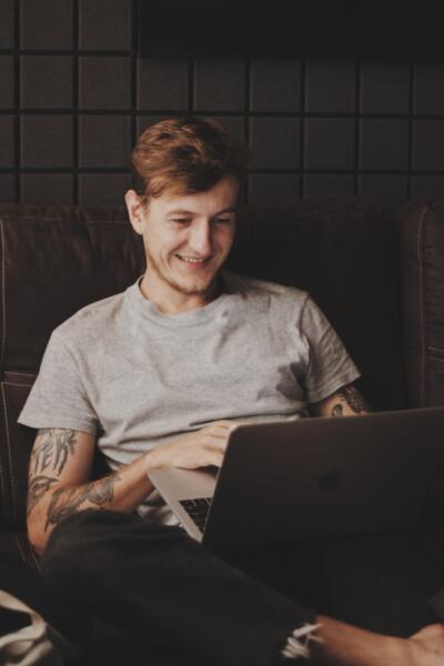 Man in grey shirt on laptop