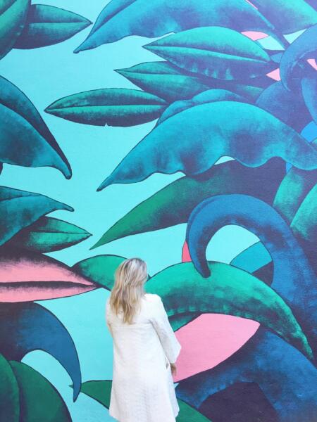 Swayer Carolina in front of blue wall art