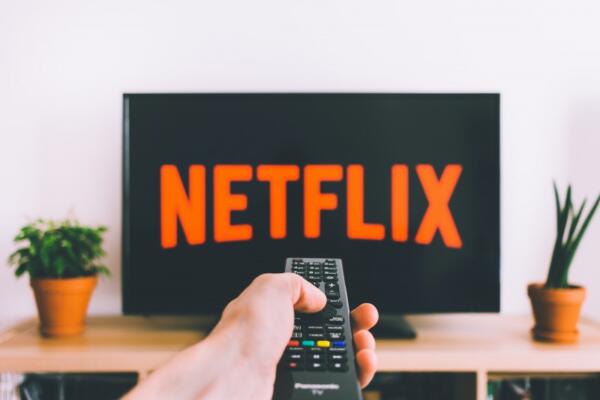 Hand with remote on Netflix