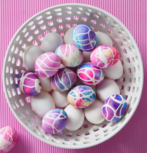 Pink, blue, and purple dyed easter eggs in bowl